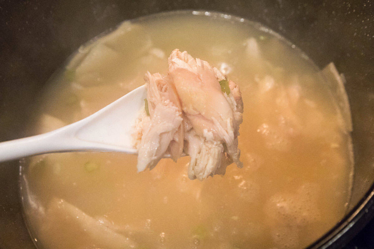 A pot of chicken and dumpling soup.
