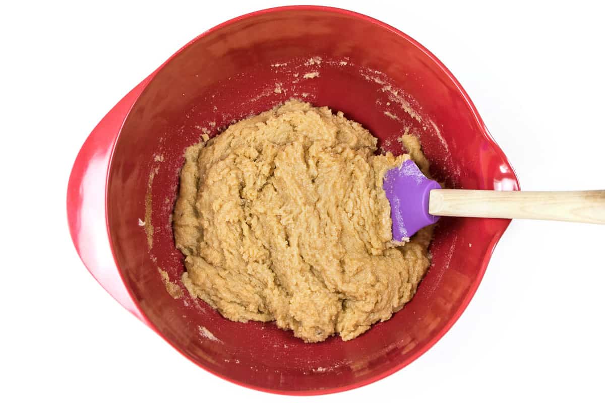 The softened butter, sugar, and light brown sugar are blended well.
