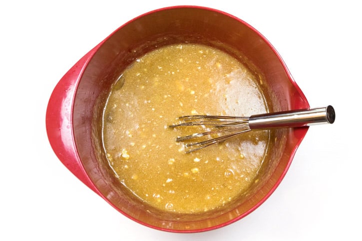 Eggs, vanilla extract, melted butter, light brown sugar, and granulated sugar in a bowl.