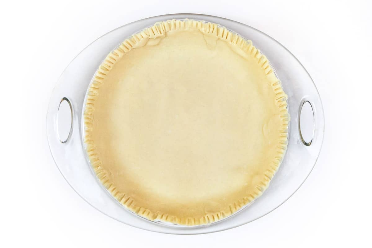 A bottom pie crust in a pie plate.
