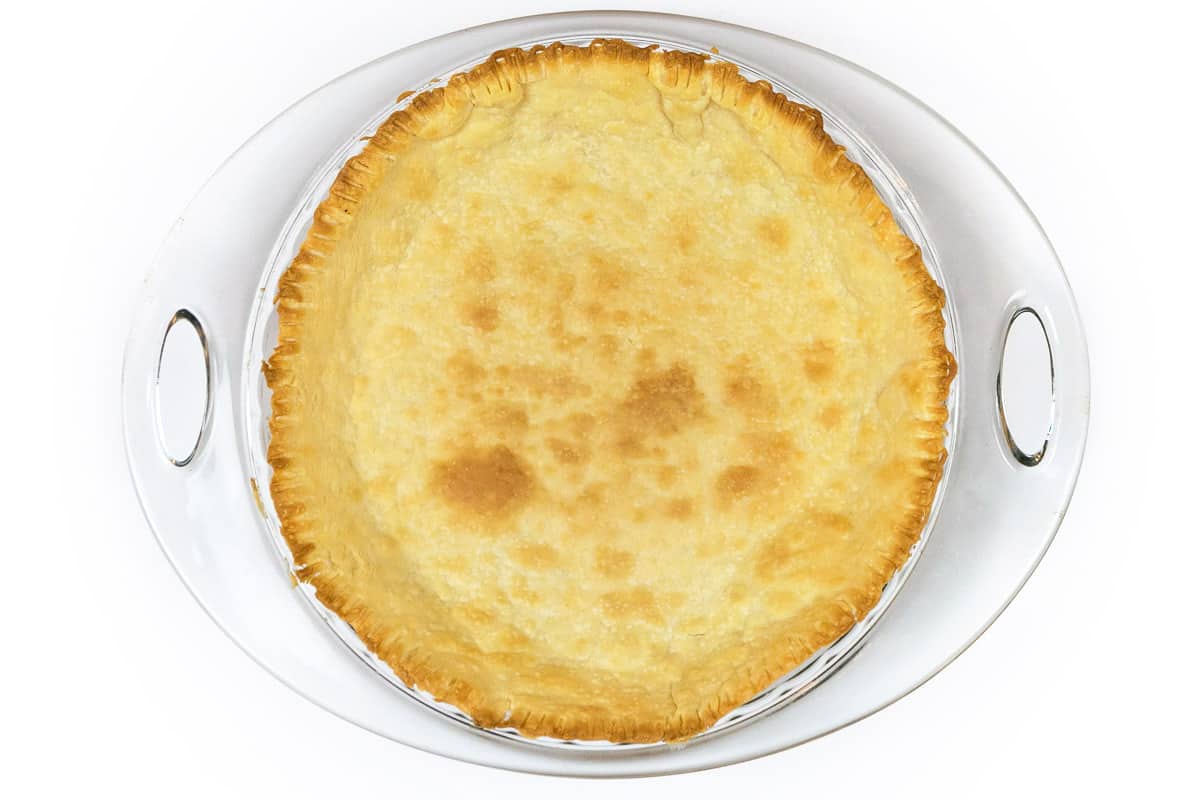 A baked bottom pie crust in a pie pan.