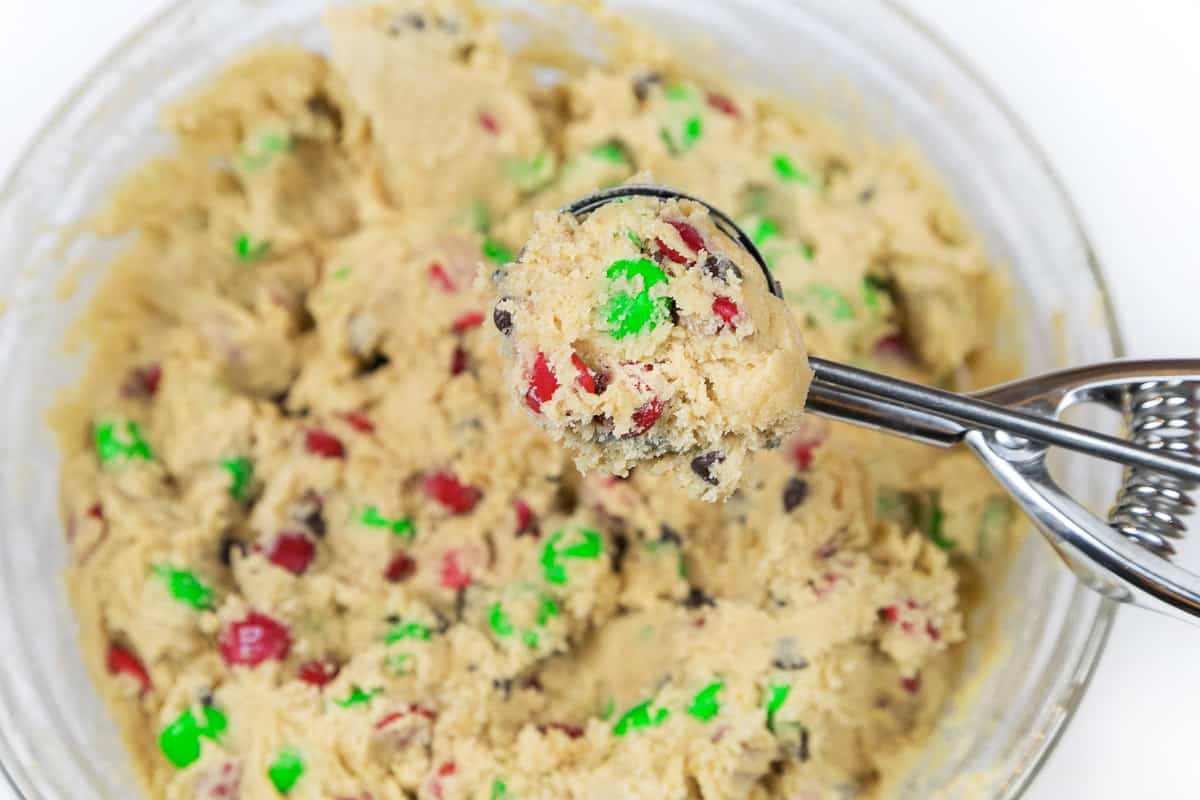 A cookie scoop with cookie dough in it.