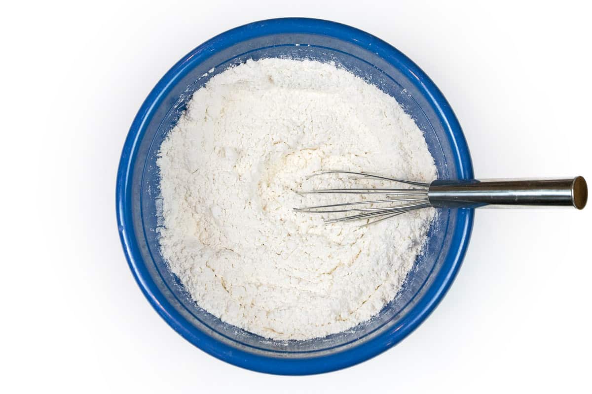 Flour, kosher salt, baking soda, and baking powder in a bowl.