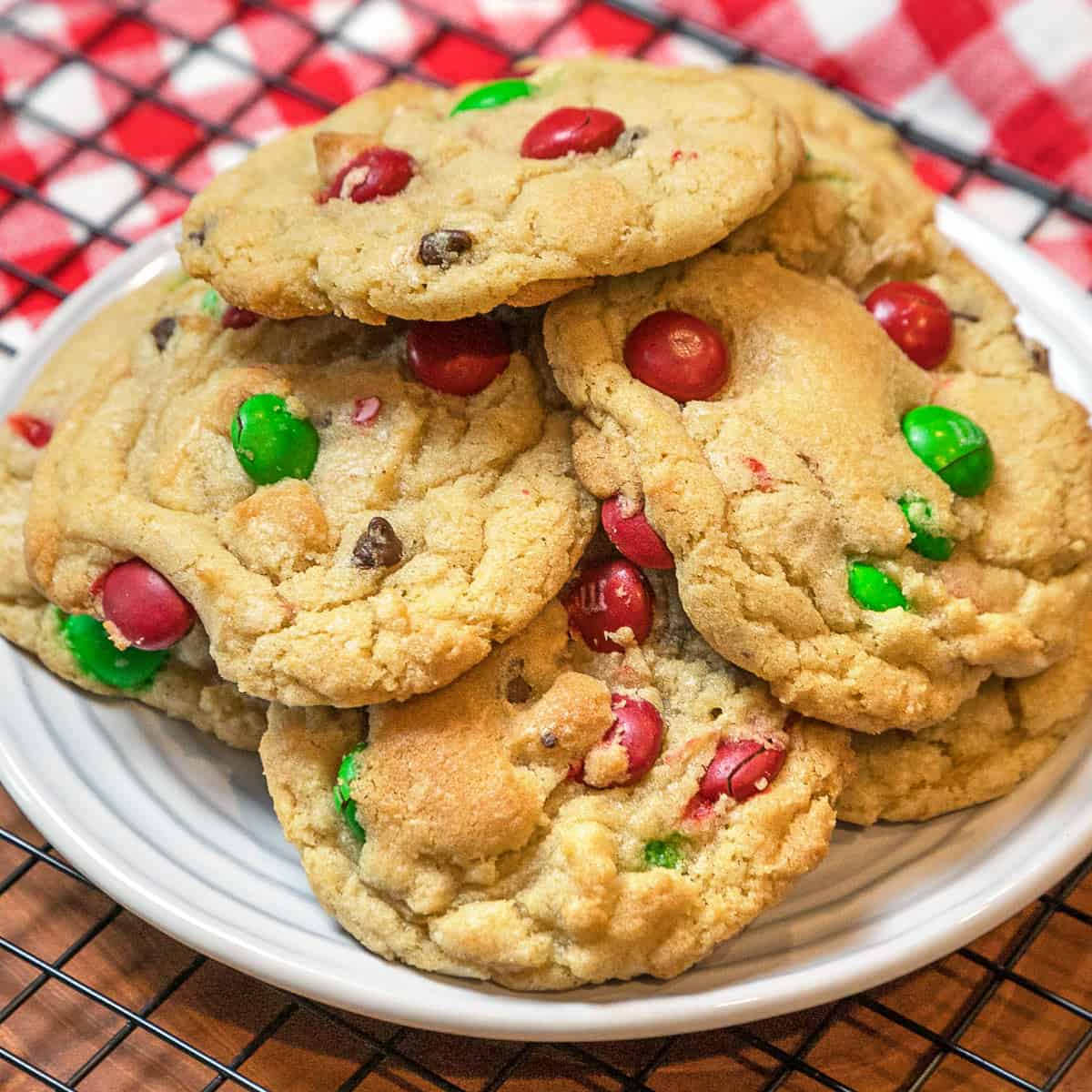 Christmas Cookies with M&Ms stacked on a plate.