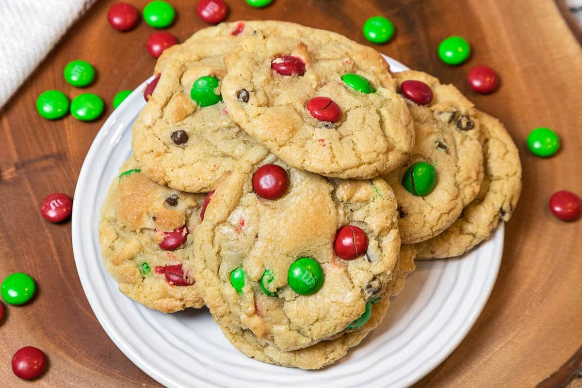 Christmas cookies with M&Ms on a white plate.