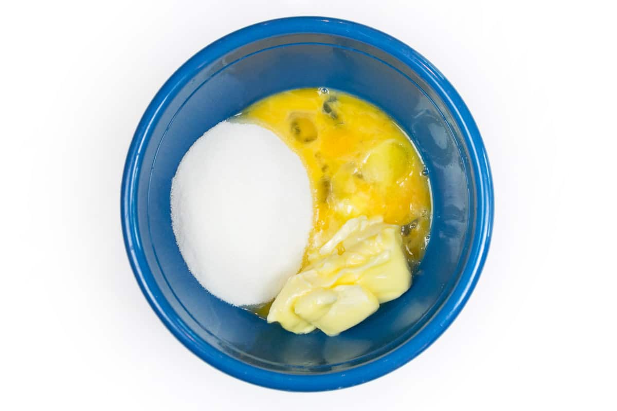 Melted butter, sugar, salt, and eggs in a bowl.