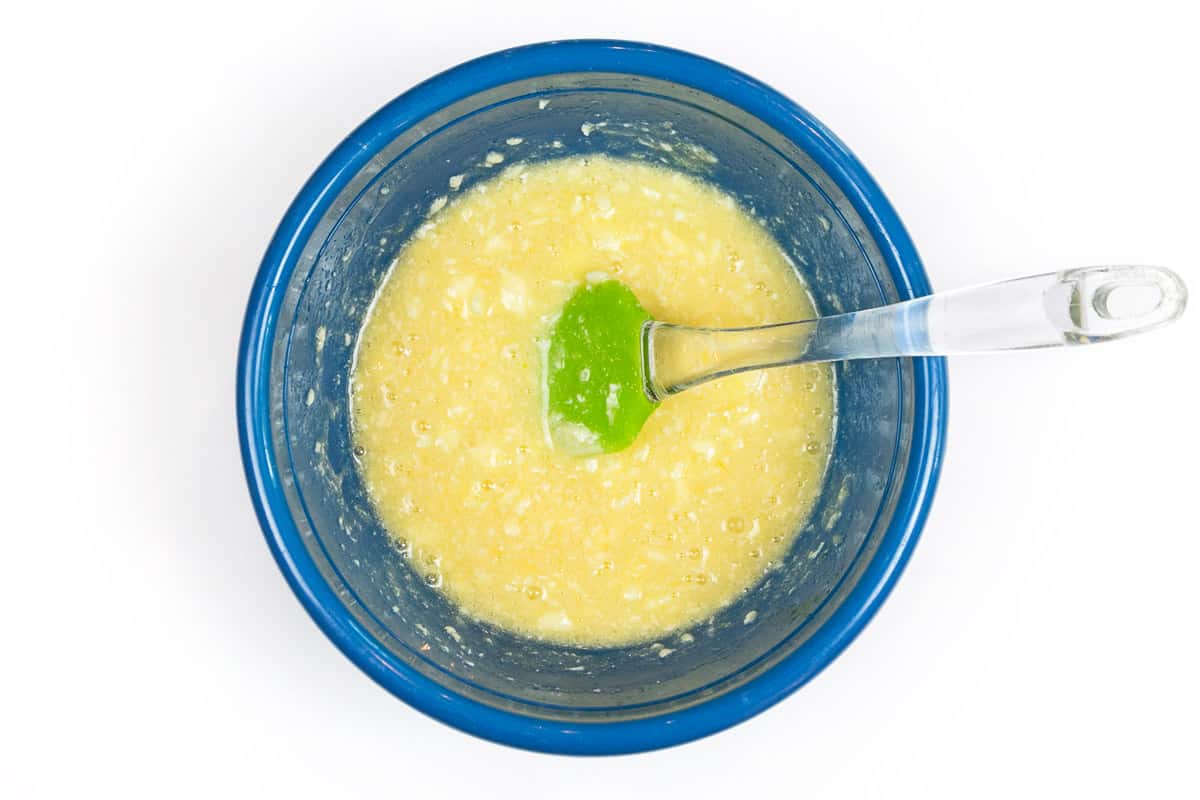 Melted butter, sugar, salt, and eggs are combined in a bowl.