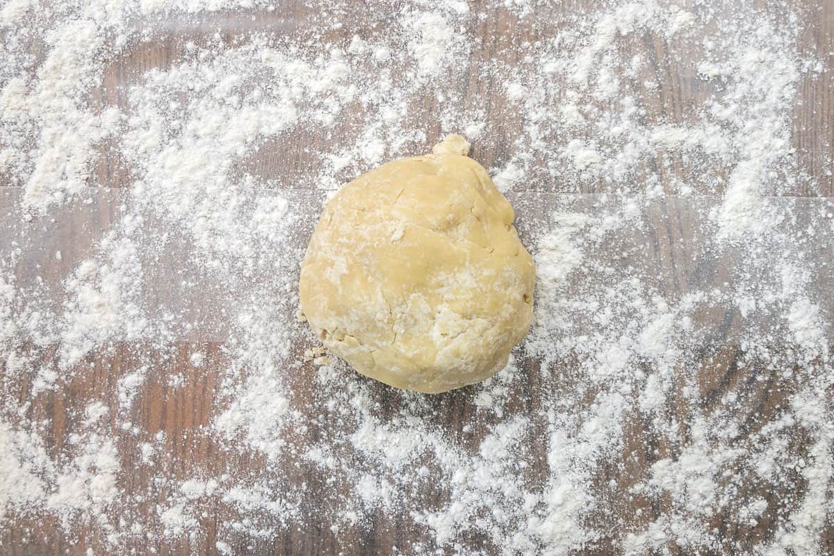 A ball of dough on a lightly floured surface.