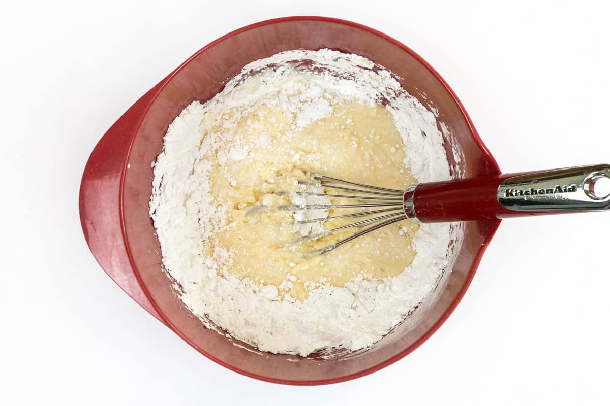 The butter mixture is added to the powdered sugar.