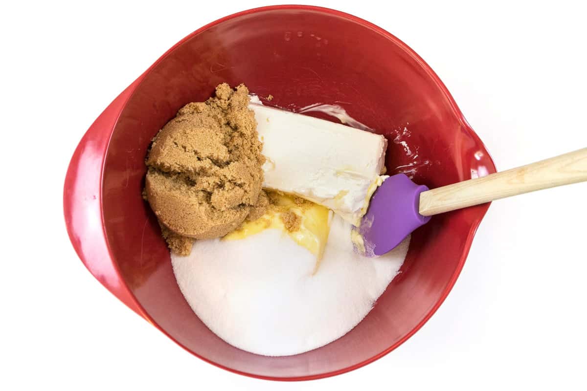 Put three-fourths of a cup of softened butter, one cup of light brown sugar, one cup of granulated sugar, and one eight-ounce brick of softened cream cheese in a bowl.