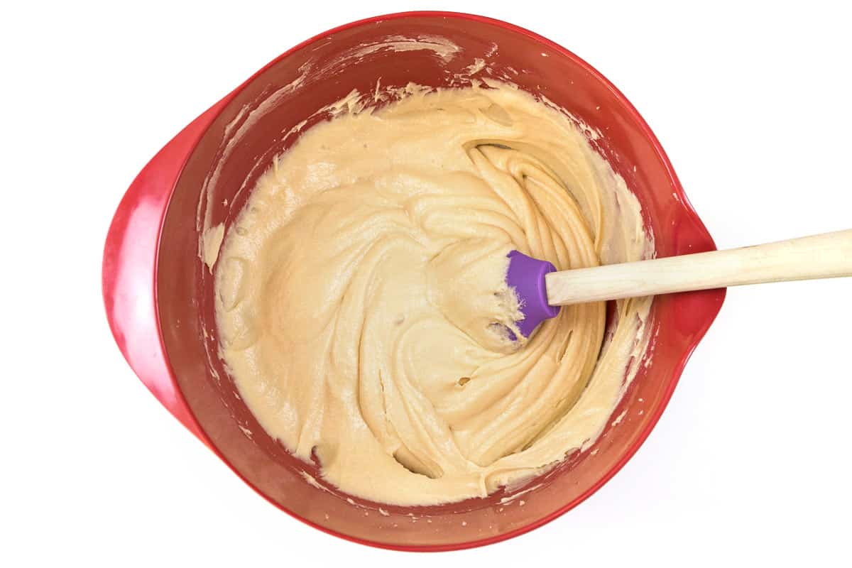 The egg and vanilla extract are mixed into the butter, cream cheese, and sugar mixture.