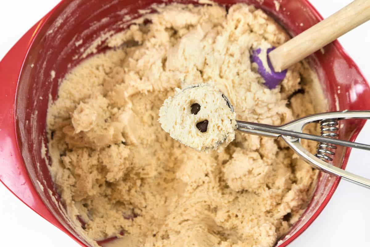 Scoop out cookie dough and hide two to four chocolate chips inside the cookie dough.