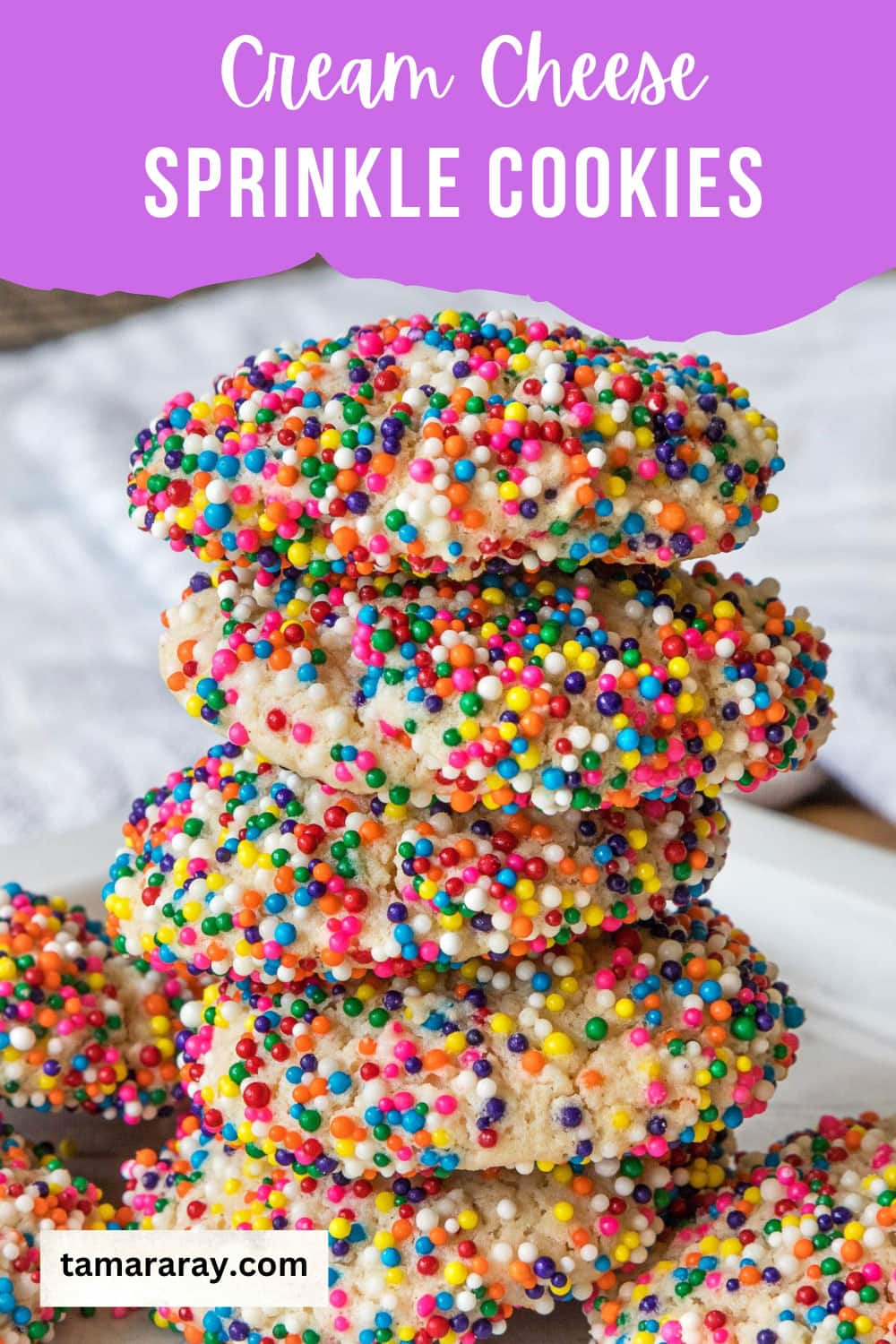 Cream cheese cookies with sprinkles on a plate.