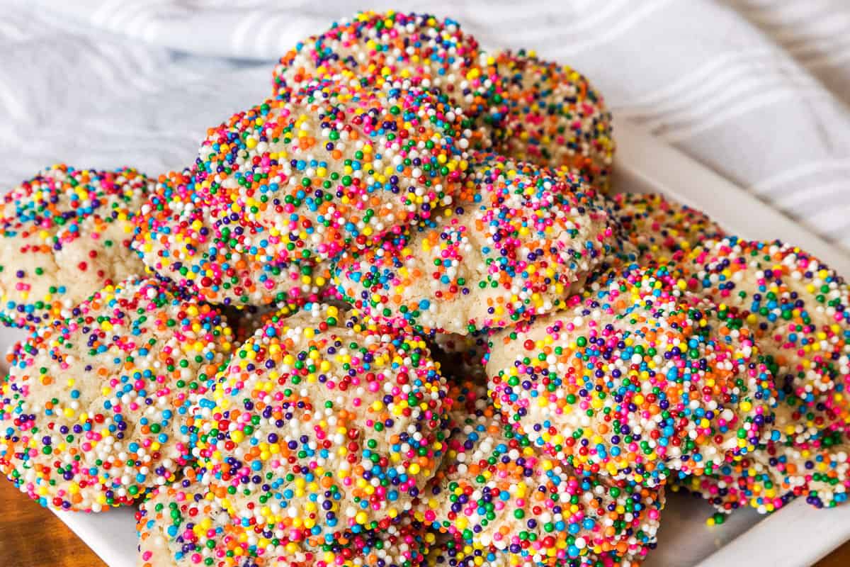 Cream cheese sprinkle cookies on a plate.