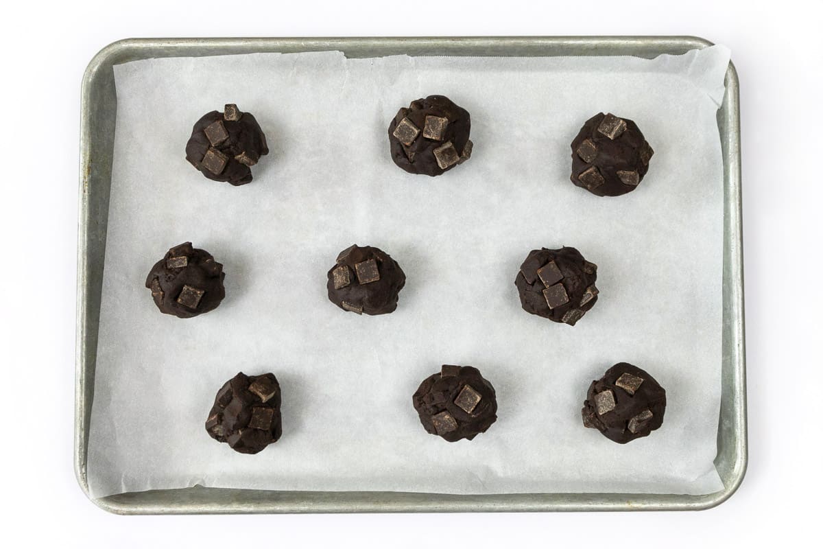 Cookie dough balls on a cookie sheet.