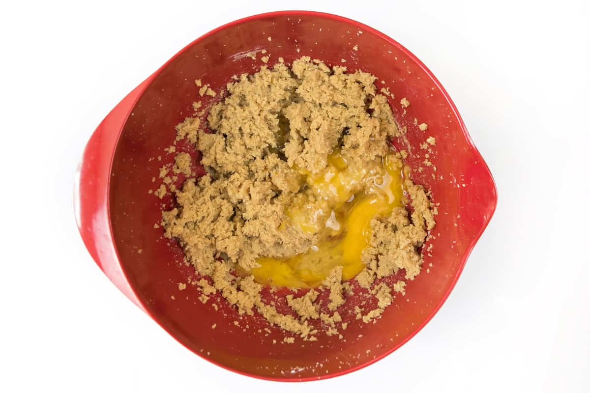Eggs and vanilla extract are added to the softened butter, granulated sugar, and dark brown sugar.