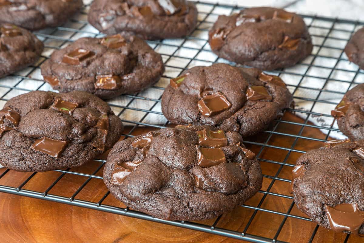 Dark chocolate cookies on a cooling rack.