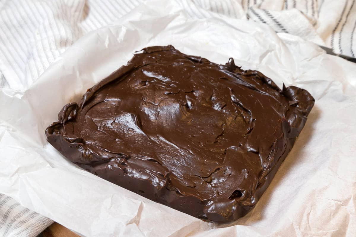 The parchment paper is removed from the fudge.