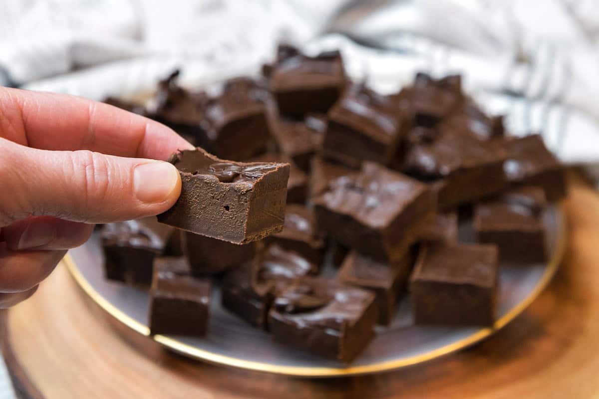 Pieces of dark chocolate fudge on a plate.