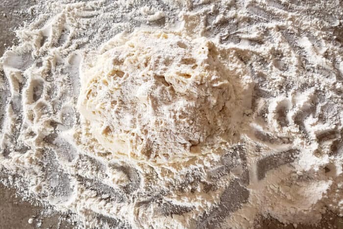 Dumpling dough on the countertop with flour.