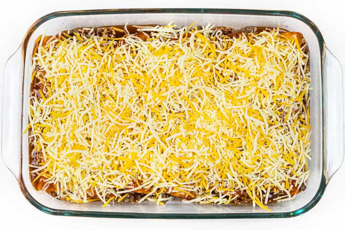 Sprinkle remaining Mexican blend cheese over the enchilada sauce on both baking dishes.