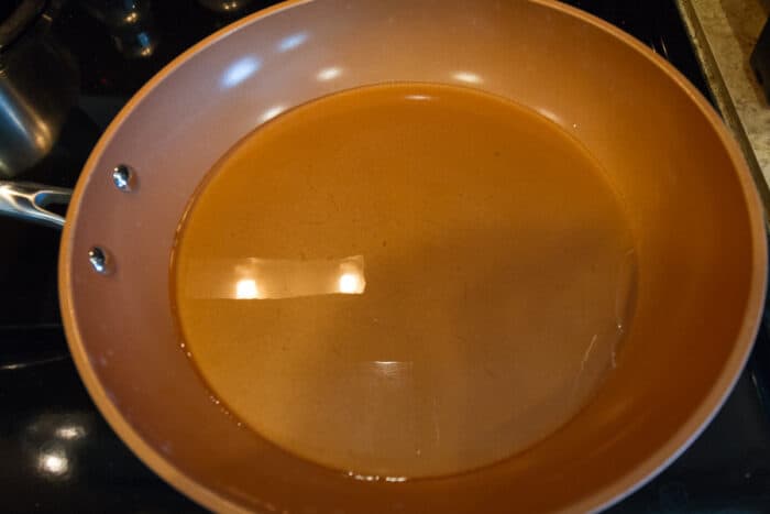 Four tablespoons of cooking oil in a frying pan.