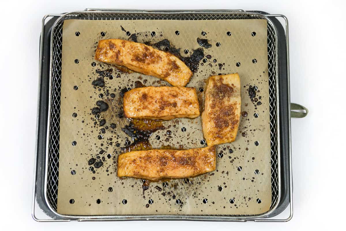 Salmon fillets are baked in the air fryer.