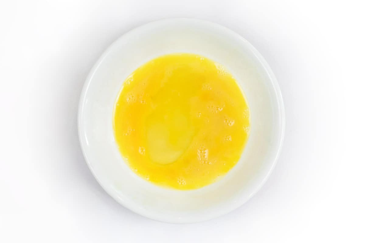 One beaten egg in a bowl.