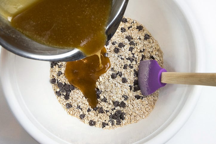 Pour corn syrup mixture into the rolled oats mixture.