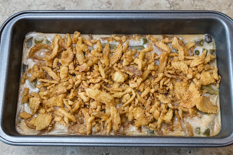 More fried onions are added to the loaf pan. Bake five more minutes.