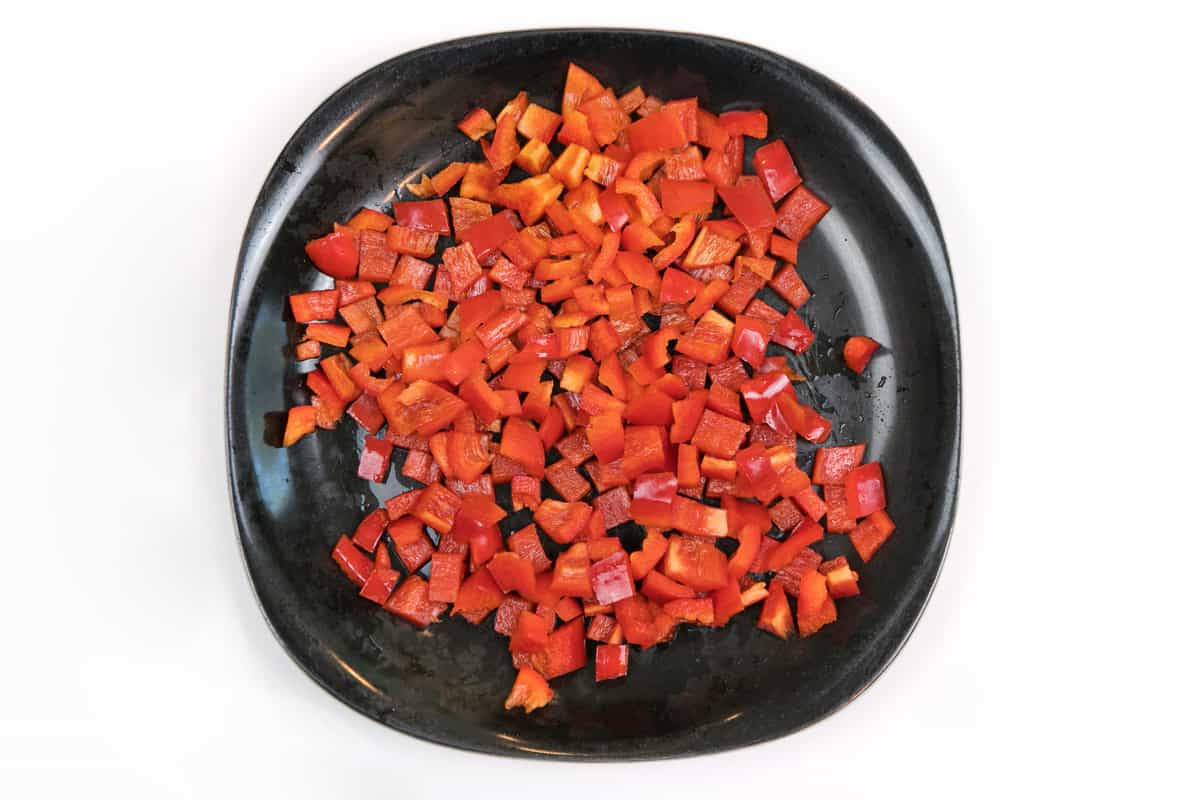 Diced red bell peppers on a plate.