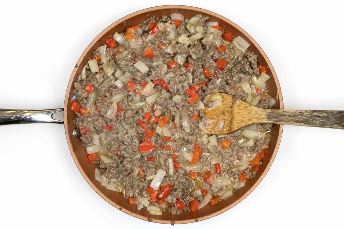 Worcestershire sauce and beef broth are added to the browned ground beef mixture.