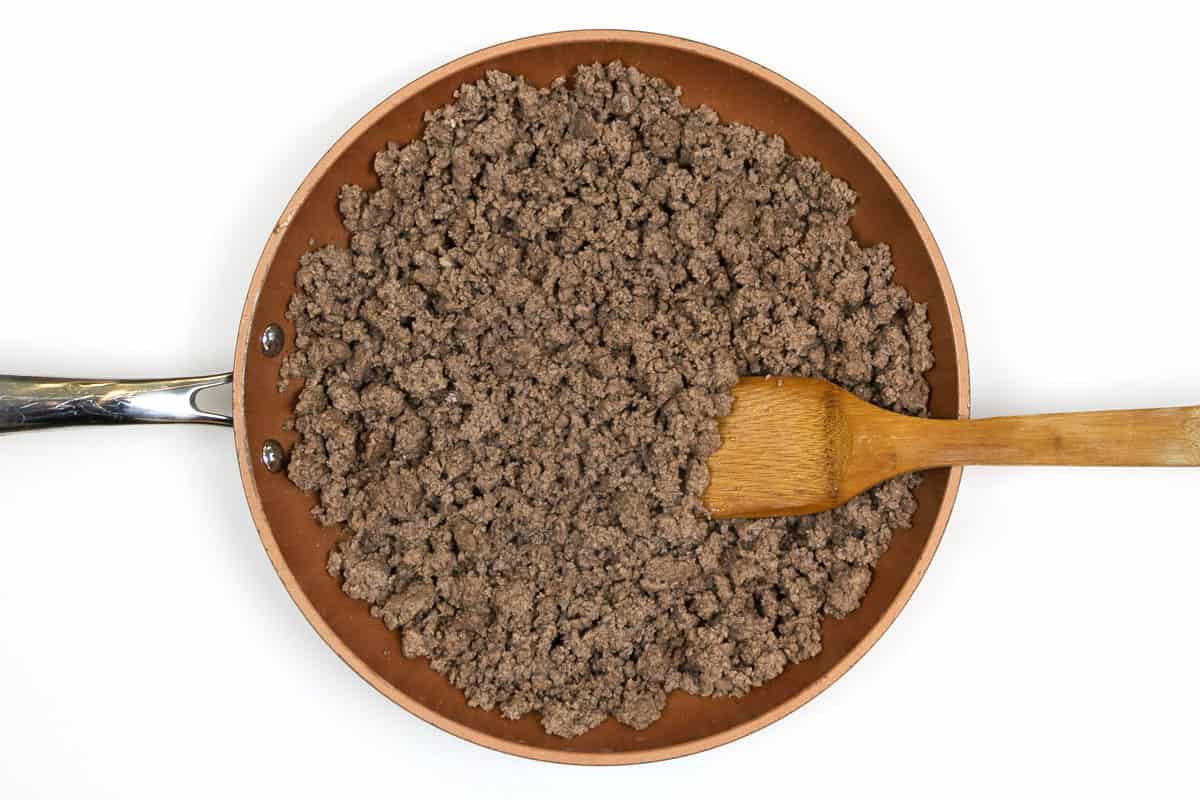 Browned ground beef in a frying pan.