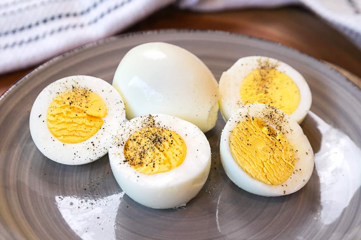 Hard-boiled eggs sliced in half with salt and pepper.