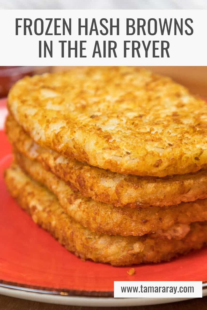 Four hash browns on a plate after being cooked in the air fryer.