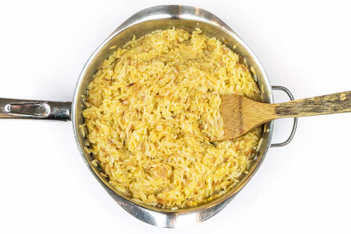 Stir the butter, cheddar cheese, salt, and black pepper into the Rice a Roni.