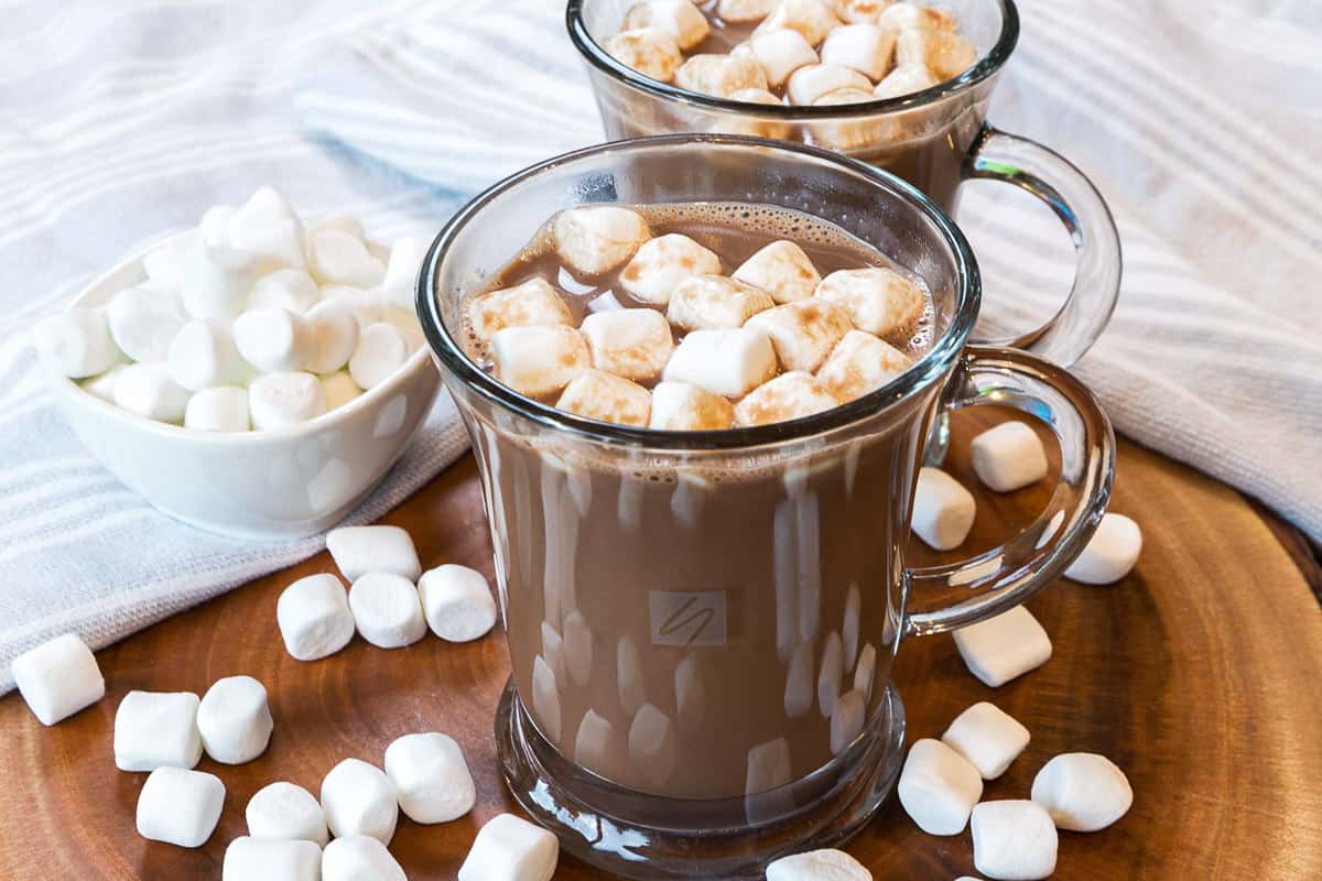 Hot Chocolate recipe with cocoa powder in a mug with marshmallows on top.
