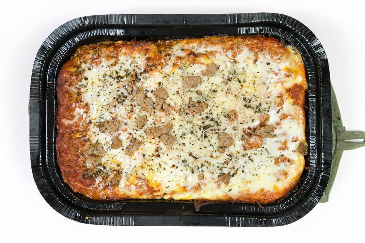 Remove the plastic wrap and bake the frozen lasagna for ten more minutes.