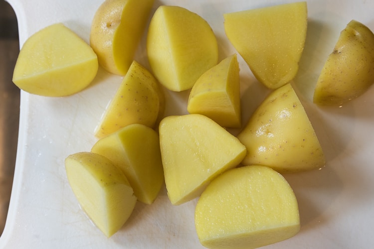 Three Yukon gold potatoes not peeled and cut into fourths.