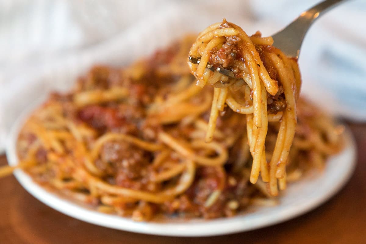 A serving of Instant Pot spaghetti with meat sauce on a plate.