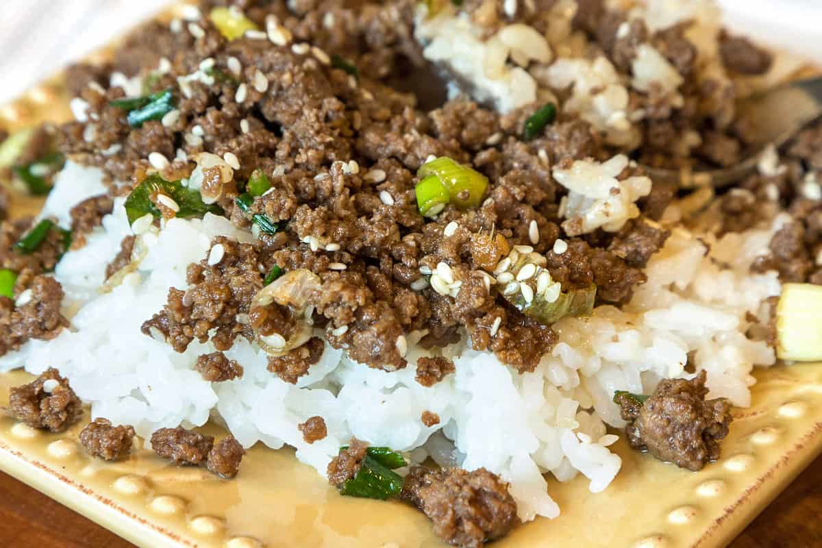 Korean style ground beef on a plate with white rice.