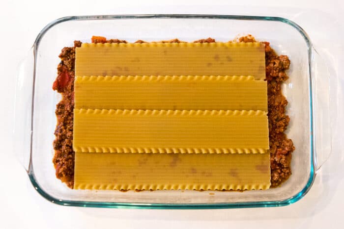 A layer of lasagna noodles over the top of the ground beef mixture.