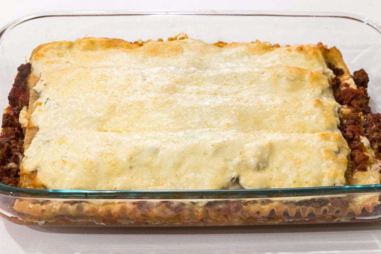 Homemade ricotta cheese lasagna in a baking dish.