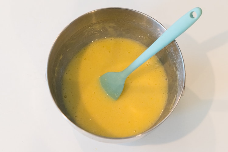 Sugar, eggs, lemon juice, flour, and baking powder in a bowl.