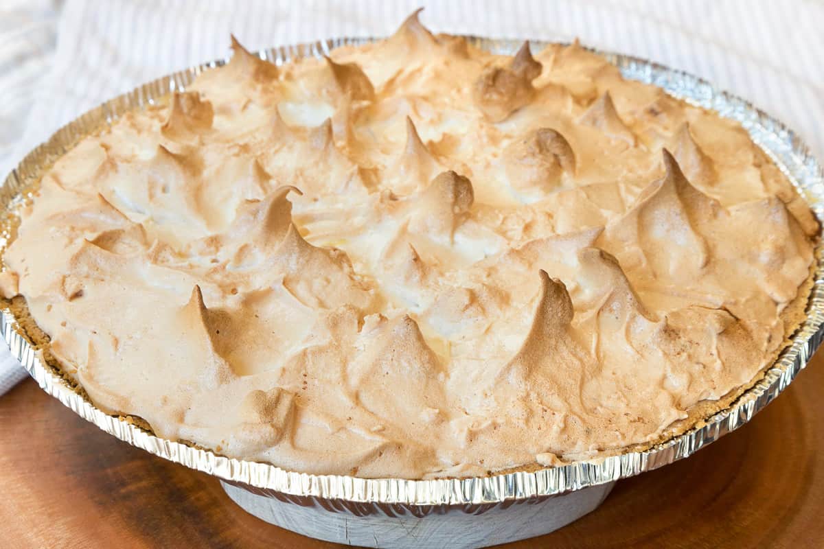 Lemon meringue pie with condensed milk baked in the oven at three hundred and fifty degrees Fahrenheit for twenty minutes.