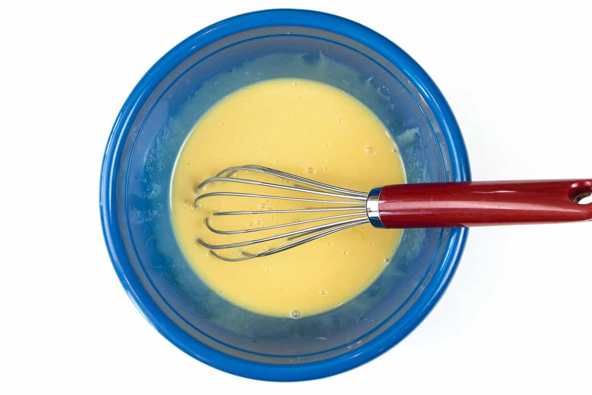 Use a whisk to blend the egg yolks with the sweetened condensed milk.