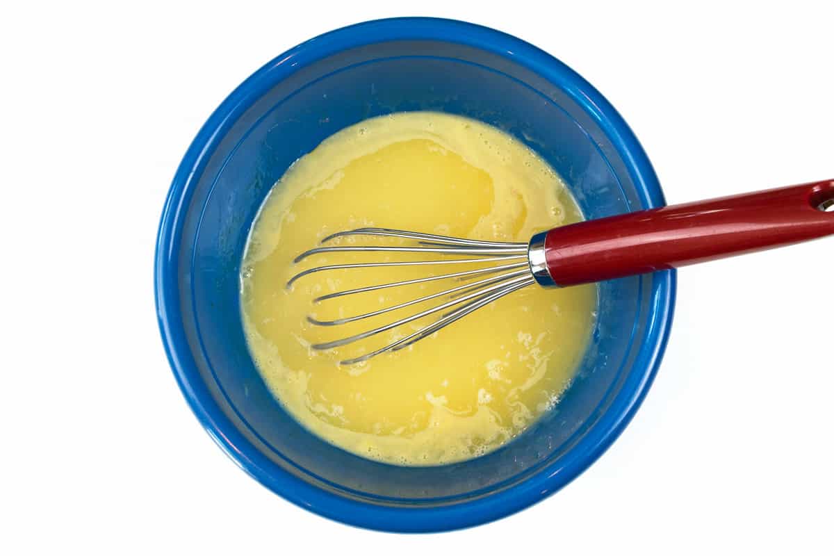 Lemon juice, egg yolks, and sweetened condensed milk in a bowl.
