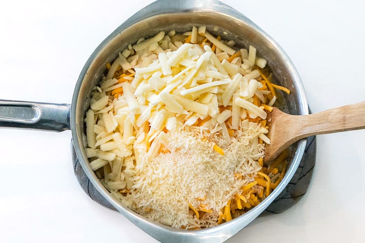Cheddar cheese, white cheddar cheese, and parmesan cheese were added to the cooked pasta shells.