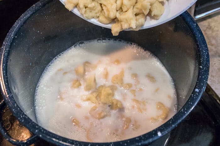 Add the dumplings to the milk and sugar mixture.