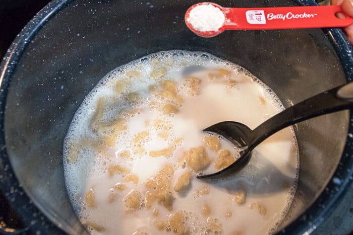 Add two teaspoons of flour to thicken the milk in the pot with the dumplings.